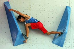 Rock Climber on indoor wall, climbing shoes